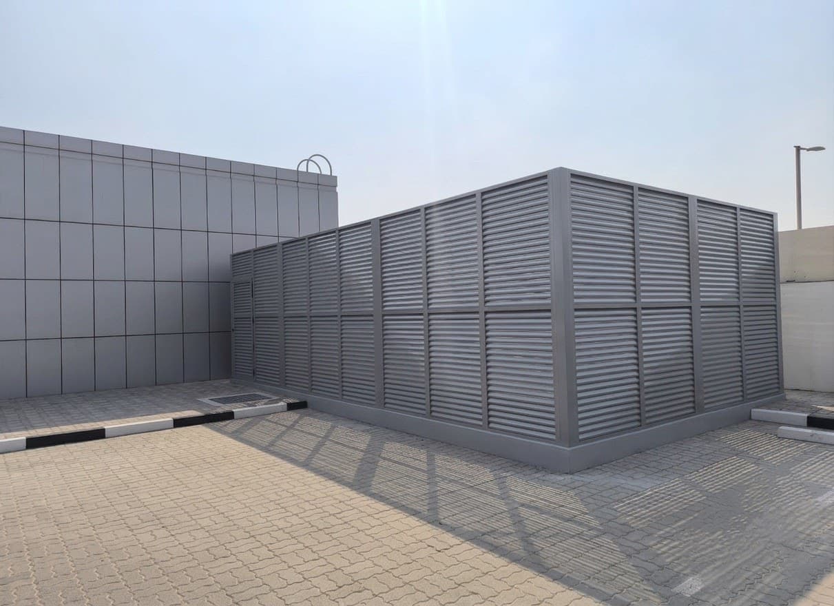 Completed generator enclosure installation beside a commercial facility